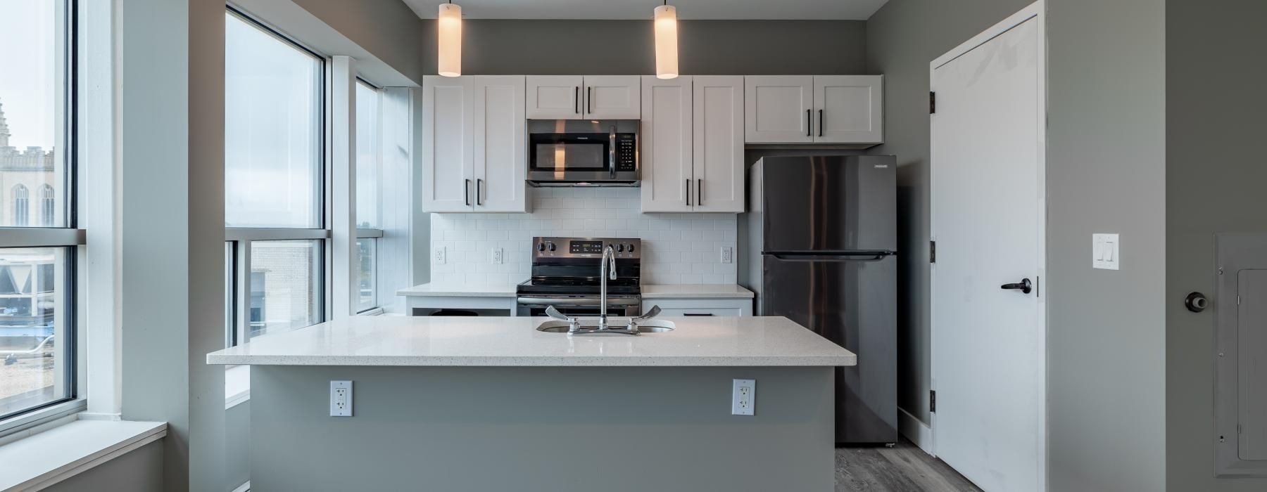 a kitchen with white cabinets