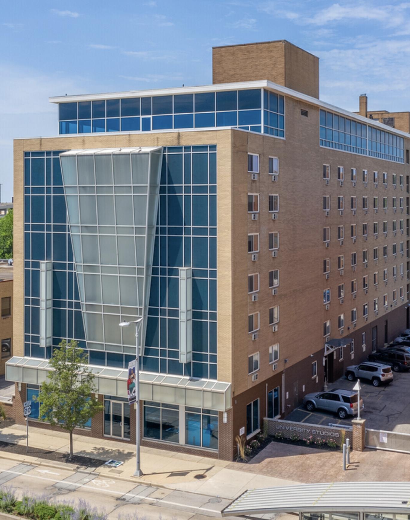 a tall building with a parking lot
