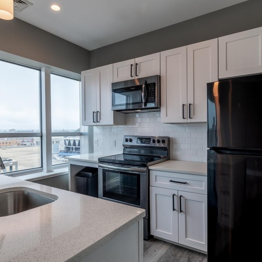 a kitchen with a black refrigerator